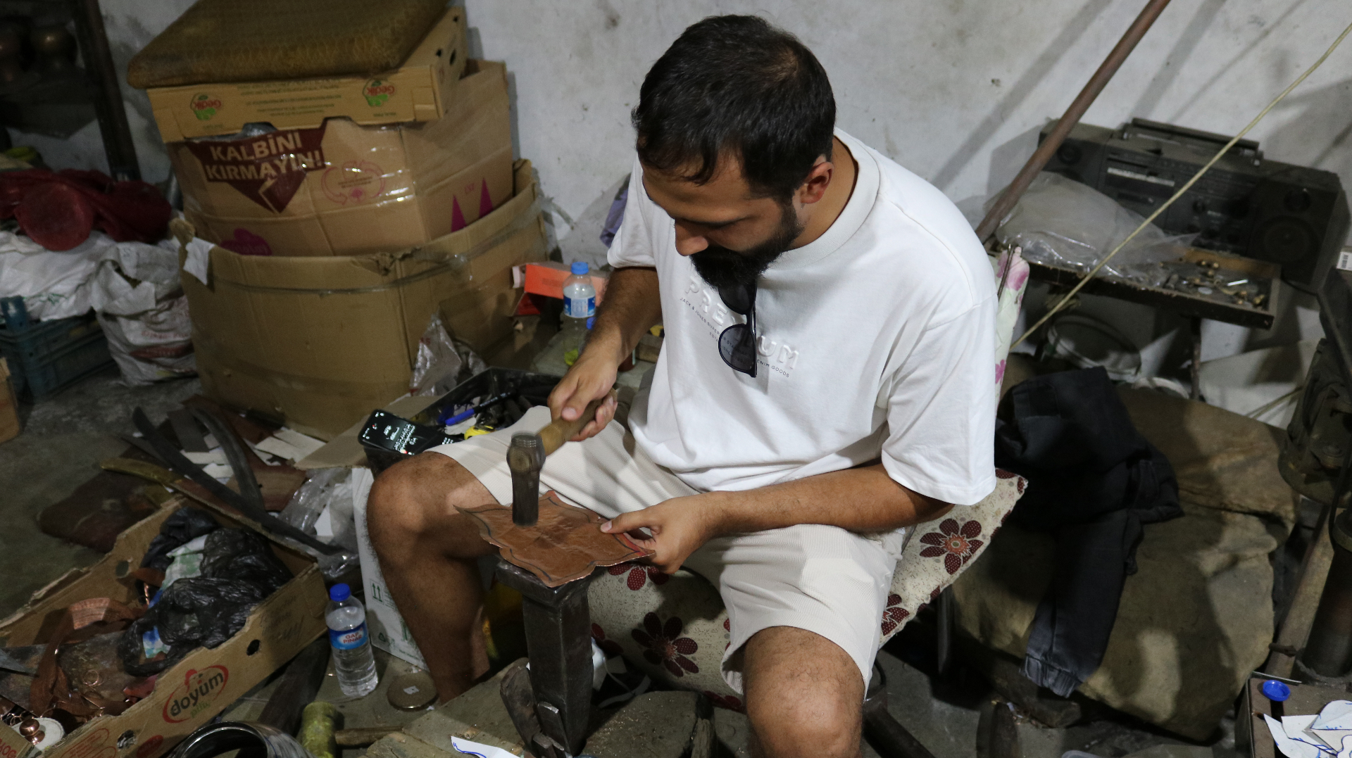 Close-up of an artisan's hands shaping a piece in the workshop