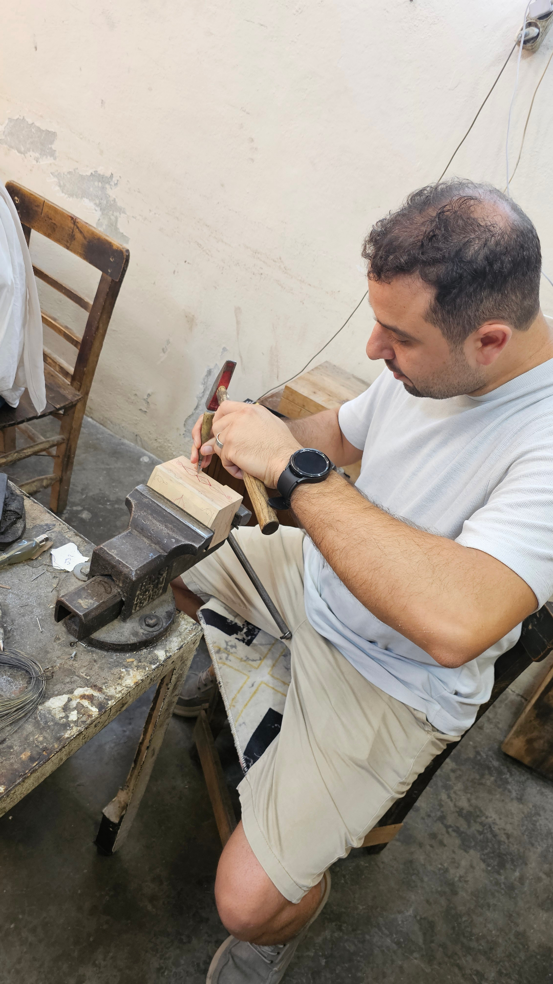 A local artisan hammering copper in his workshop